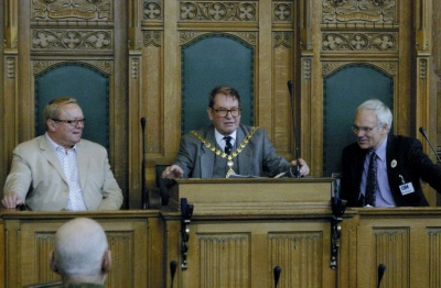 Ray Collins, John Gallagher, and Ross Burgess at a CHE meeting in Ealing Town Hall, 8 October 2011; Michael Brown has his back to the camera