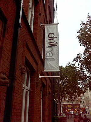 Outside of the theatre showing banner with its name